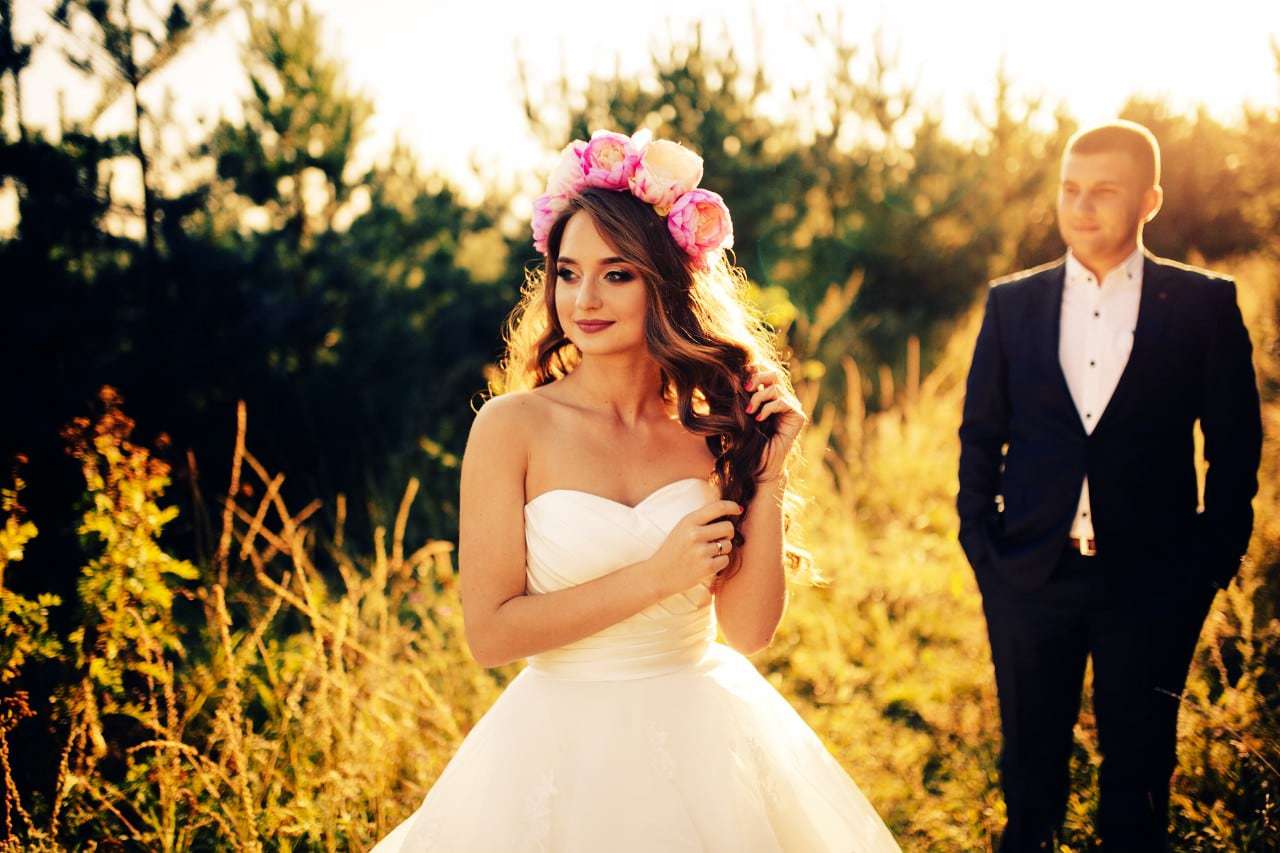 Beautiful bride with flowers on her head and wedding dress