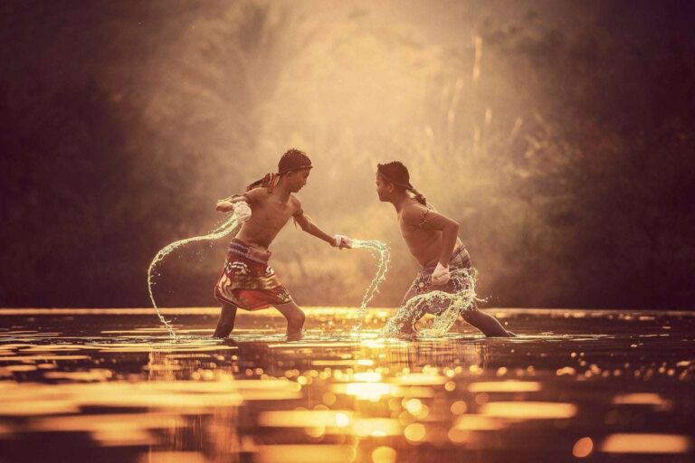 Two asian boys fighting in the water