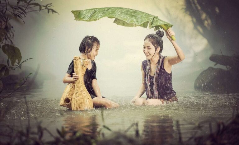 Two asian women being happy in the rain