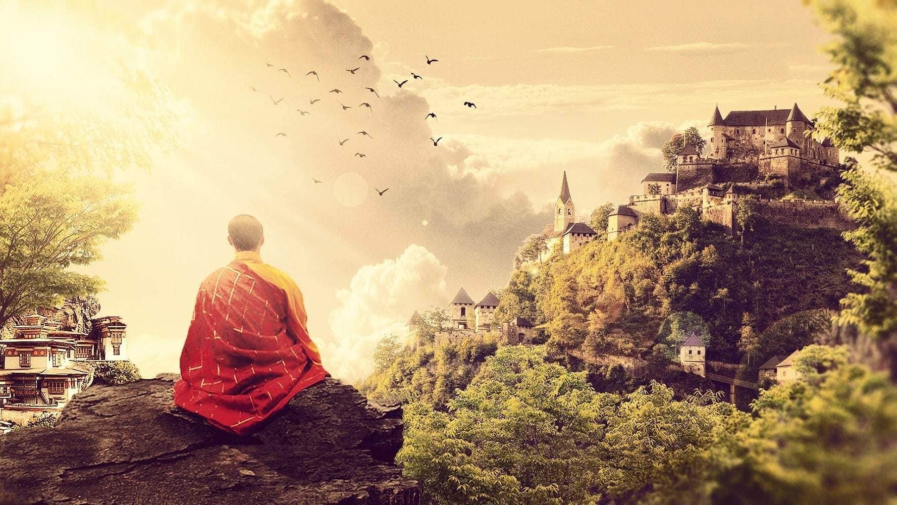 Monk meditating on a mountain