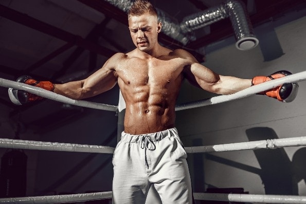Muscular kickboxing man in ring