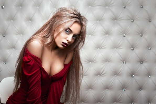 Sexy portrait of blonde long haired women in red dress