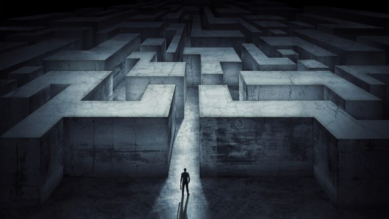 Businessman standing at the start of a maze